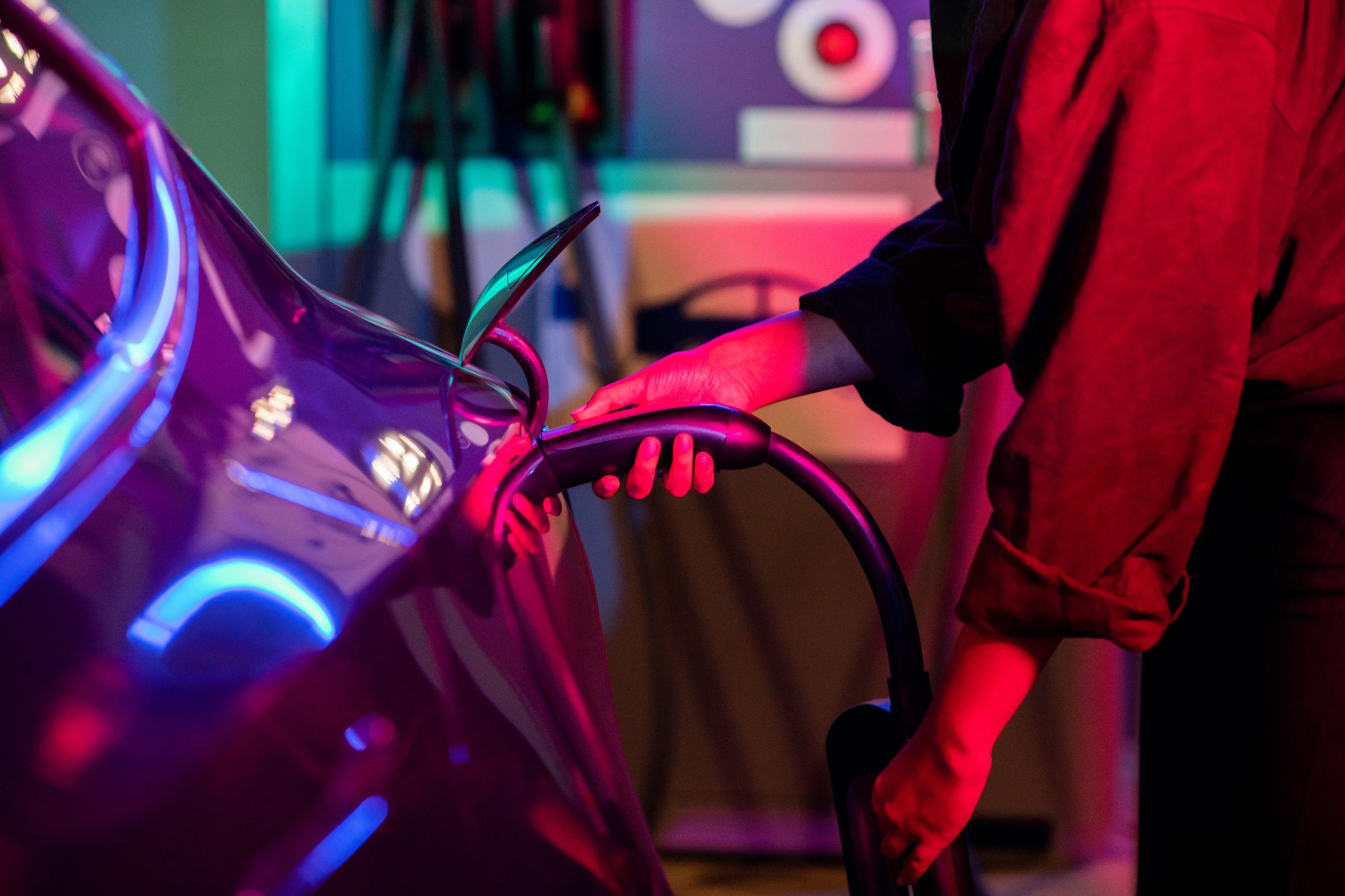 young woman holding charger of electric car during 2023 11 27 05 16 04 utc scaled